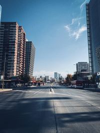 City street by buildings against sky