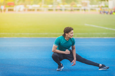 Young man exercising at stadium