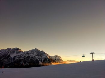 Scenic view of snowcapped mountains against clear sky