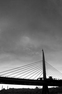 Low angle view of suspension bridge against sky