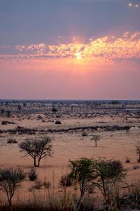 Scenic view of sea against romantic sky at sunset