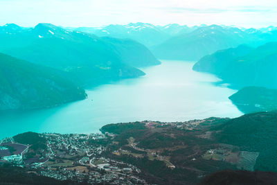 High angle view of sea and mountains against sky