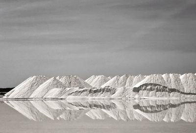 Scenic view of lake against mountain during winter