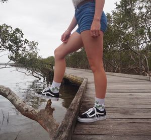 Low section of woman walking on road