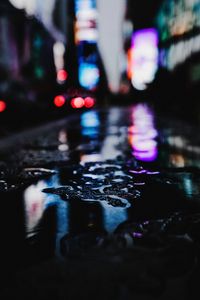 Reflection of illuminated car in puddle