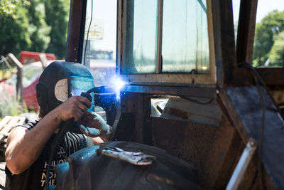 Young man welding in workshop