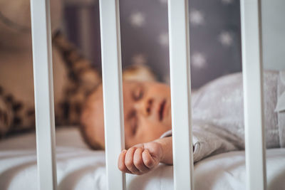 Close-up of baby sleeping on bed