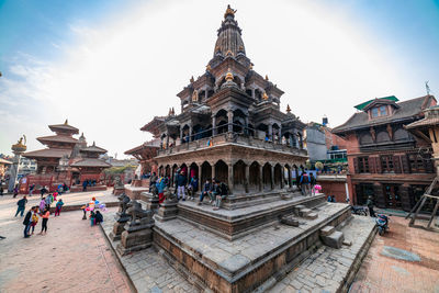Group of people in temple outside building