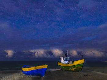 Fishing boats on the baltic sea beach at night