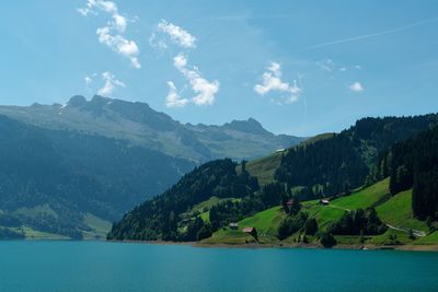 Scenic view of lake and mountains against sky