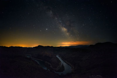 Scenic view of mountains against sky at night