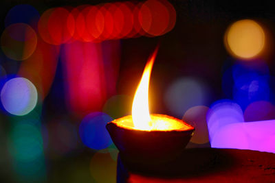 Close-up of illuminated candles or diya during diwali celebrations 