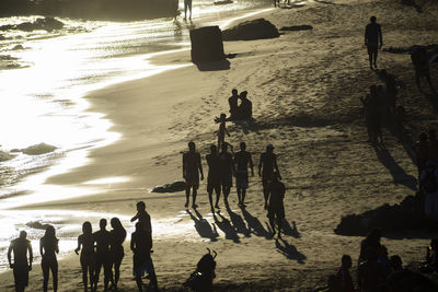 Group of people walking on beach