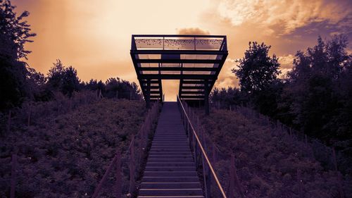 Railroad tracks amidst trees against sky