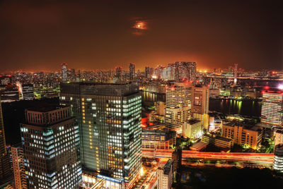 High angle view of illuminated city buildings at night