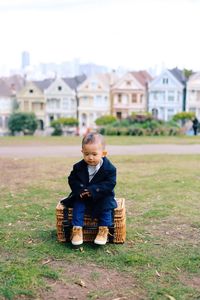 Girl sitting on grassy field