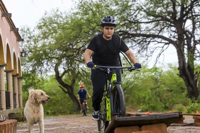 Full length of a man riding a dog