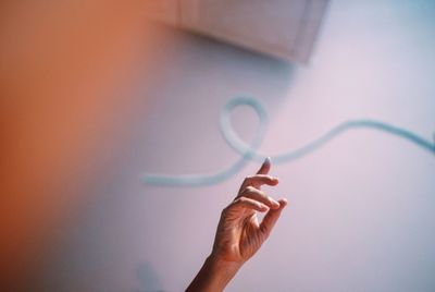 Cropped hand of woman touching pipe