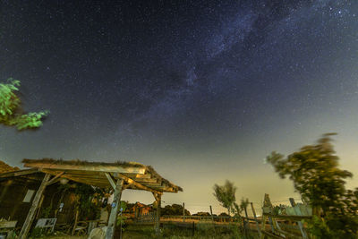 Rural environment landscape. starry sky with milky way over farm. light pollution concept.