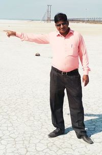 Full length of young man standing at beach