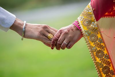 Cropped couple holding hands