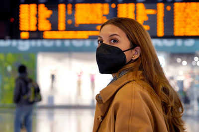 Traveler woman wearing a black protective mask kn95