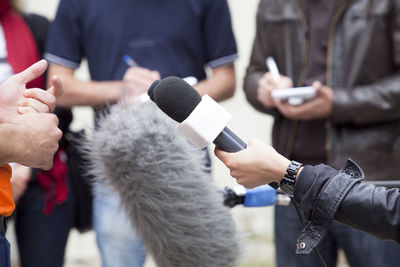 Midsection of woman holding mobile phone