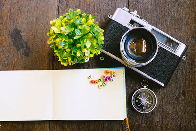 Directly above shot of camera and album on table