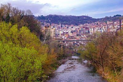 River amidst trees against sky during autumn