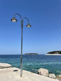 Scenic view of sea against clear blue sky