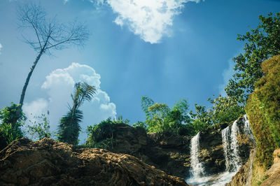 Scenic view of waterfall against sky