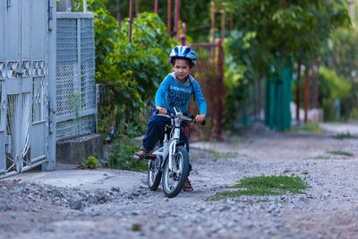 Boy riding bicycle on road