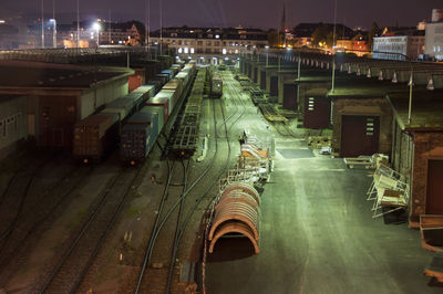 High angle view of illuminated railroad tracks at night