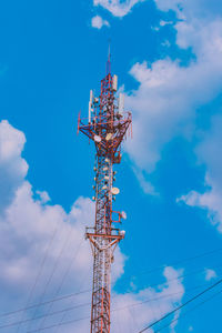 Low angle view of communications tower against blue sky