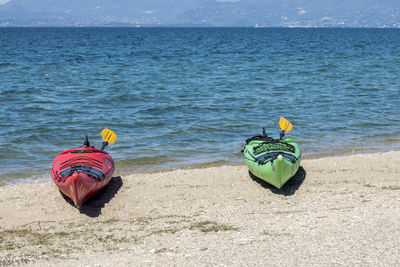 Kayaks on shore at beach