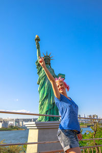 Low angle view of statue against clear blue sky