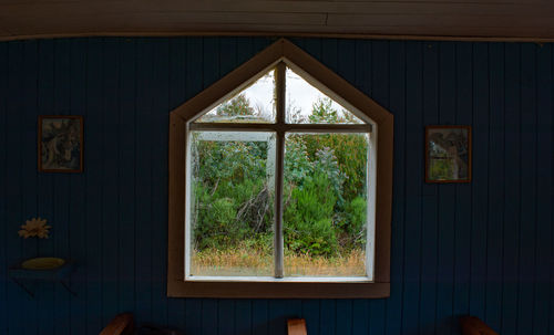 Looking out of the window of an all wooden church in chiloe, chile.