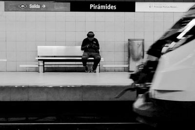Full length rear view of man at railroad station