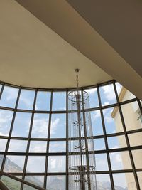 Low angle view of glass window against sky