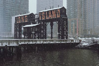 Reflection of building on frozen canal in city