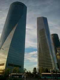 Low angle view of modern building against cloudy sky