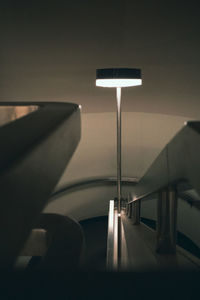 Close-up of illuminated electric lamp on table