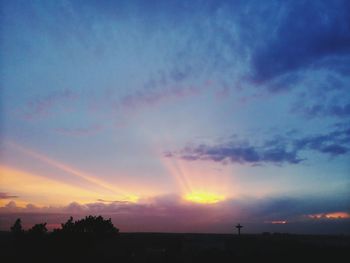 Scenic view of rainbow against sky at sunset