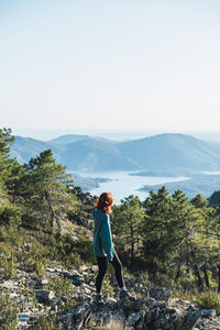 Man standing on mountain against clear sky