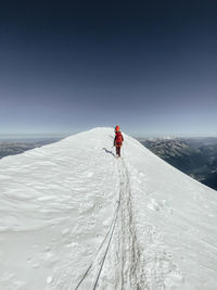 Two climbers ascending mont blanc roped together