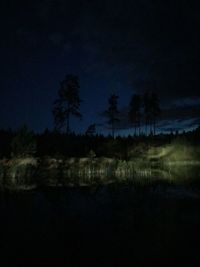 Scenic view of lake against sky at night