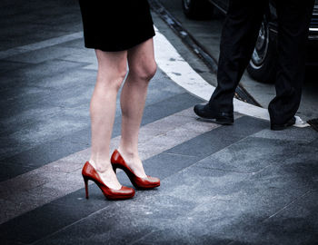 Low section of people walking on street