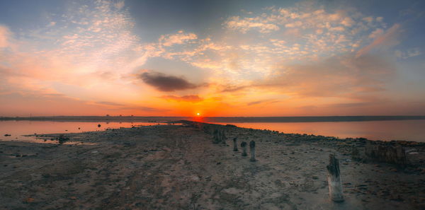 Scenic view of beach against sky during sunset