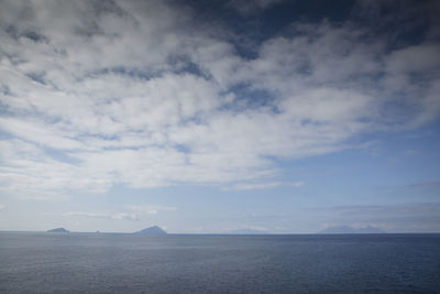 Scenic view of sea against cloudy sky