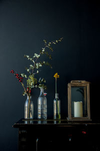 Close-up of flower vase on table against black background